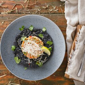 Hawaiian poke on black sesame flat cake. Modern restaurant food